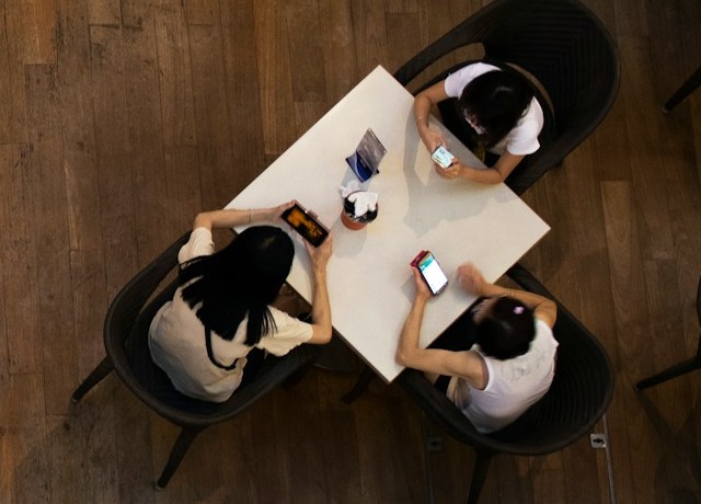 Guests at a table, each ordering from their own phone